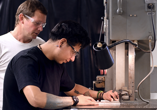 faculty helps student machining
